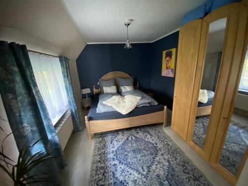 a small bedroom with a bed and a mirror at Holiday home with 2 bedrooms in Neu Sankt Jürgen