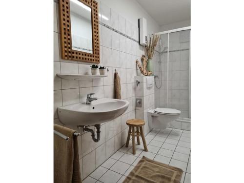 a bathroom with a sink and a toilet at Watt do you want sea in Sahlenburg