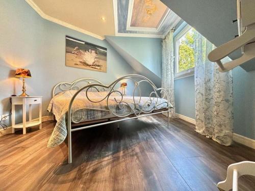 a bedroom with a bed and a large window at One-bedroom apartment in Lantershofen