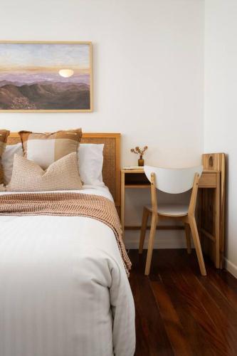 a bedroom with a bed and a desk and a chair at Bilinga Breeze - Walk to North Kirra Beach and Airport in Gold Coast