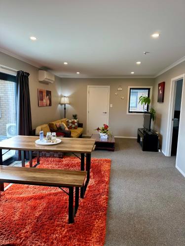 a living room with a table and a couch at The heart of Palmerston North in Palmerston North