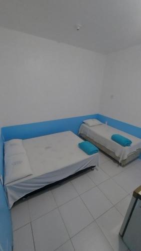 two beds sitting in a hospital room with at Pousada Casa Sonhos in São Luís