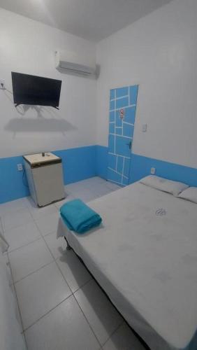 a small room with a bed and a tv at Pousada Casa Sonhos in São Luís