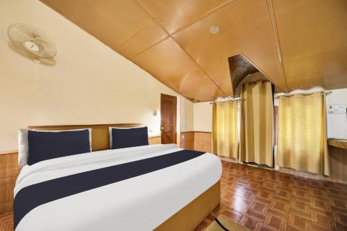 a bedroom with a large bed in a room at Hotel O Hilton Resorts and Spa in Baragrān