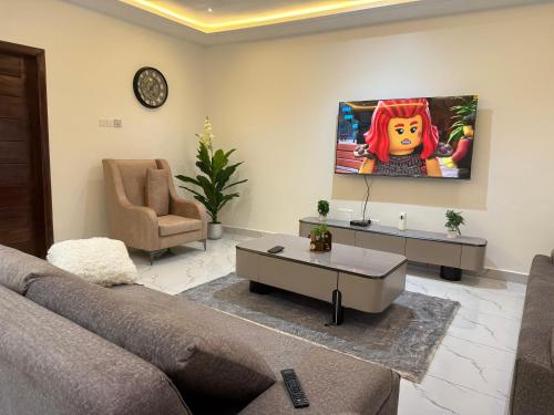 a living room with a couch and a table at Cosdarl Homes in Nsawam