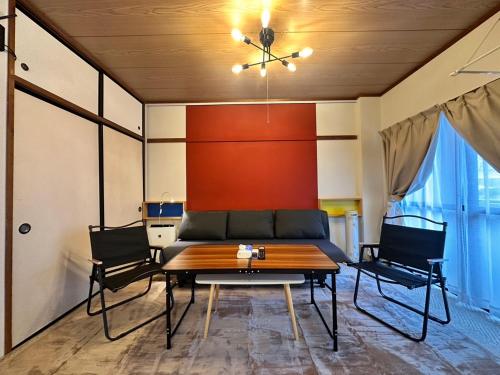 a dining room with a table and two chairs at Nikko Kinugawa Stay in Nikko