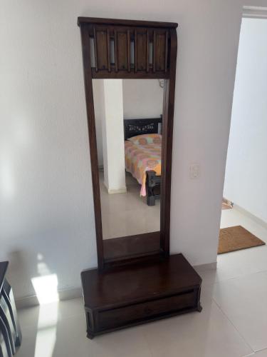 a mirror sitting on a wooden stand in a room at Posada Three Cay Suites in Providencia