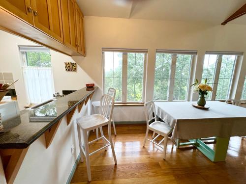 a kitchen and dining room with a table and chairs at The Rivery Retreat, Choose from Luxury Guesthouse Cabin OR Poolside Suite in Lake Austin Hill Country in Austin