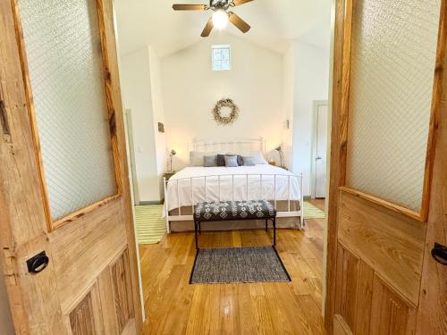 a door leading into a bedroom with a bed at The Rivery Retreat, Choose from Luxury Guesthouse Cabin OR Poolside Suite in Lake Austin Hill Country in Austin