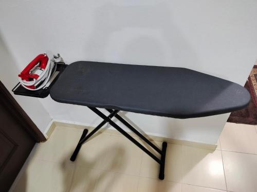 a black table with a helmet sitting on top of it at Liza Homestay in Bachok