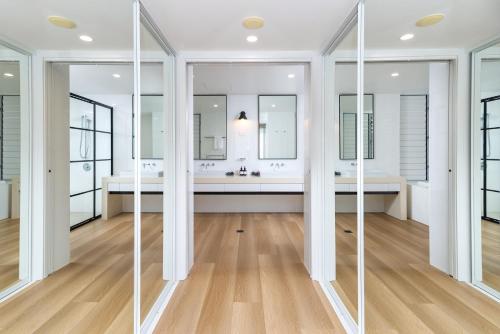 a bathroom with two sinks and mirrors at Drift Palm Cove in Palm Cove