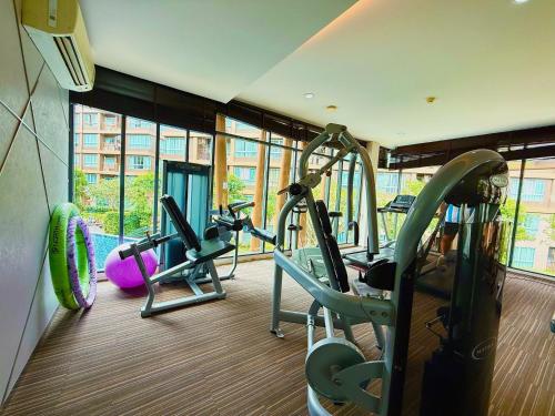 a gym with two treadmills and two exercise bikes at Spacious 1 Bedroom, with sofa bed and Balcony in Kathu