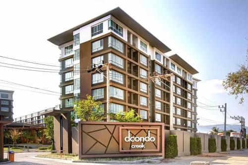 a tall building with a sign in front of it at Spacious 1 Bedroom, with sofa bed and Balcony in Kathu