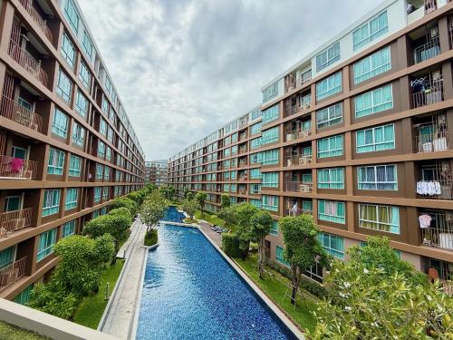 an apartment complex with a river between two buildings at Spacious 1 Bedroom, with sofa bed and Balcony in Kathu
