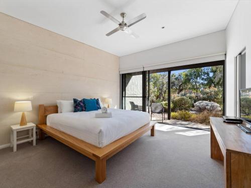 Un dormitorio con una cama grande y una ventana grande. en Inji Dreaming - Bushland Retreat near Injidup Beach, en Yallingup