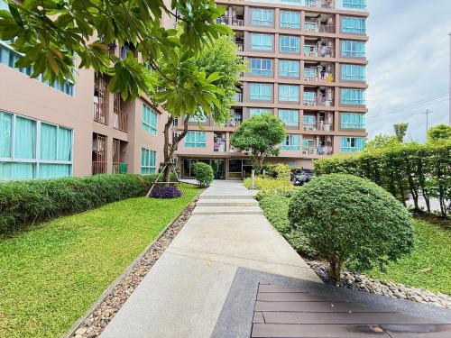 a sidewalk in front of a large building at Spacious 1 Bedroom, with sofa bed and Balcony in Kathu
