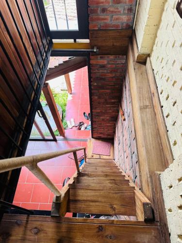 a wooden staircase in a building with a window at Duong Lam Eco Home in Sơn Tây