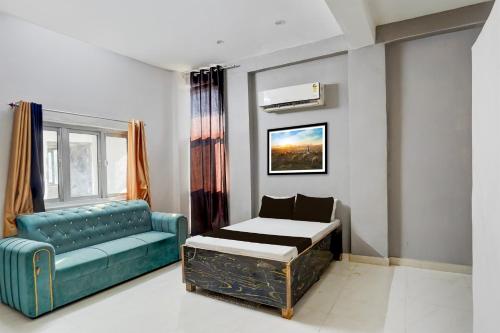 a living room with a couch and a table and a chair at Hotel O Raj Palace in Bāra Banki
