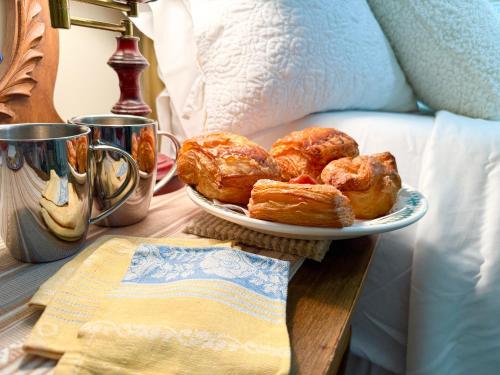 a plate of pastries on a table next to a bed at The Rivery Retreat, Choose from Luxury Guesthouse Cabin OR Poolside Suite in Lake Austin Hill Country in Austin