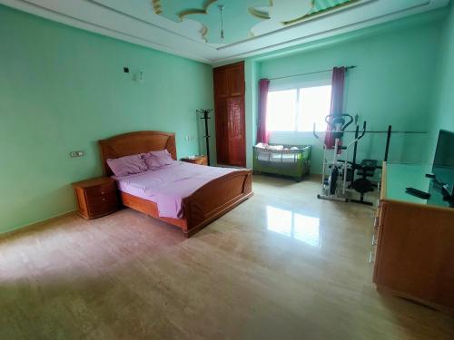 a bedroom with a bed and a television in it at Célia House in Fès