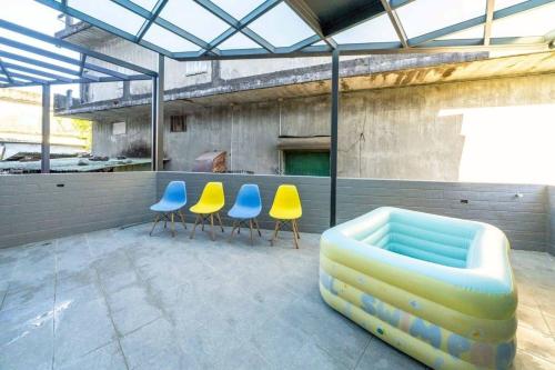 a group of chairs and a couch on a patio at 海燕民宿 in Suao