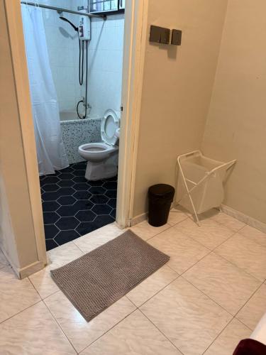 a bathroom with a toilet and a shower at Green Cove Villa A Famosa Karaoke Netflix Private pool in Simpang Empat