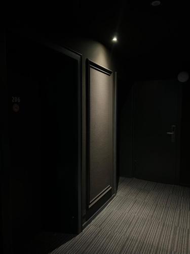 an empty room with an open door in the dark at Hotel Monopol City Centre in Düsseldorf