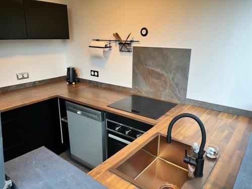 a kitchen with a sink and a stove at Love and spa by O'Kalm in Le Gosier
