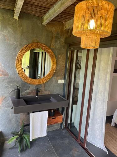 a bathroom with a sink and a mirror at Love and spa by O'Kalm in Le Gosier