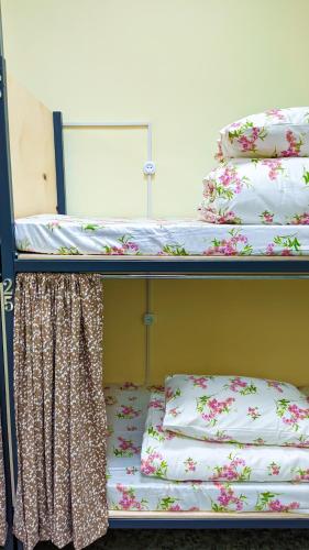 two bunk beds with pillows on them in a room at Sun Hostel in Almaty