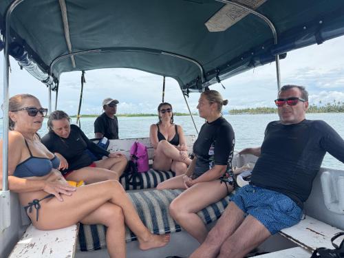 a group of people sitting on the back of a boat at San Blas Cayos Holandeses, Anaimar 