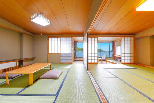 an empty room with a table and chairs at Ooedo Onsen Monogatari Nanki Kushimoto in Kushimoto