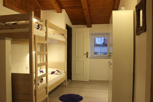 a room with two bunk beds and a window at Hostel Angelina Old Town in Dubrovnik