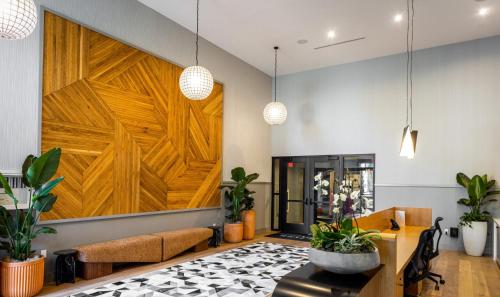a living room with a large wooden door at Noho Alexan Modern 2bed Duo with FREE Parking in Garnsey