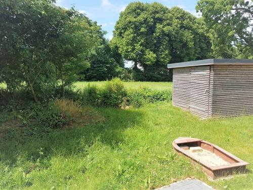 a wooden shed in a field with a wooden boat at Holiday home in Harrislee with barbecue in Harrislee