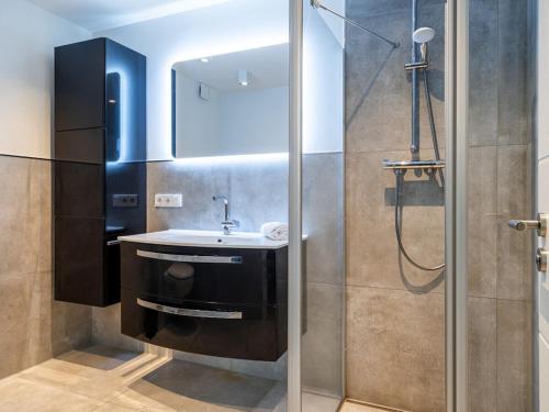 a bathroom with a sink and a shower at Holiday apartment with 2 bedrooms in Greetsiel