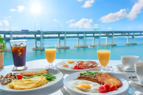 a table topped with plates of breakfast food and drinks at AG405 Hotel in Busan