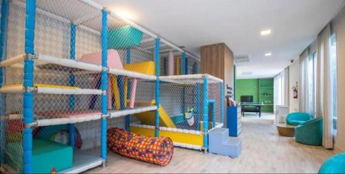 a childrens room with a play area with a play structure at 2 quartos no melhor Cond em Pinheiros Thera Faria Lima in Sao Paulo
