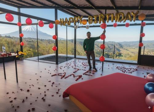 a man standing in a room filled with birds at SUITE frente al Cotopaxi in Tanicuchí