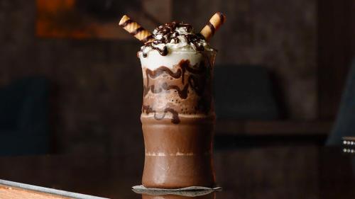 a chocolate and whipped cream milkshake in at فندق فيو الشاطي - Beach View Hotel in Dammam