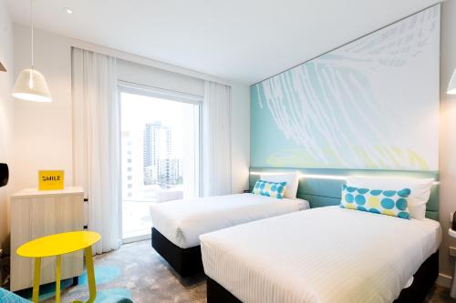 a hotel room with two beds and a window at ibis Styles East Perth in Perth