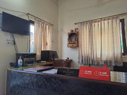 an office with a desk with a computer on it at Hotel O Country Lodge in Dharamshala