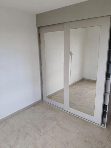 a sliding glass door in a room with a tile floor at Hacienda Valbuena Antorcha area in León