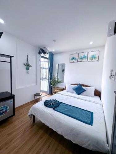 a bedroom with a large bed and a television at New World Hotel in Hue