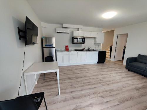 a living room with a table and a kitchen at One bedroom unit for corporate stays & travellers in Halifax