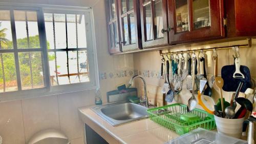 a kitchen with a sink and a counter with utensils at A Few Steps to Malecon and Sunny Beaches in Las Flores