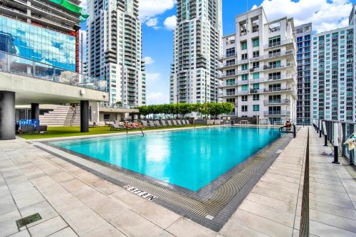 a large swimming pool in a city with tall buildings at Luxury studio Miami in Miami