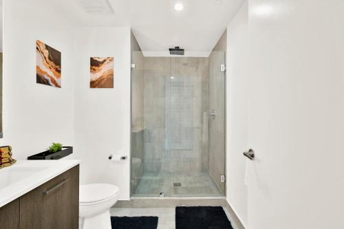 a white bathroom with a shower and a toilet at Luxury studio Miami in Miami