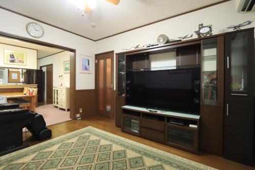a living room with a large flat screen tv at 日田ホステル　Hita Hostel in Hita