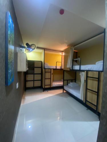 a room with three bunk beds and a ceiling at Hoi An Ancient Town Hostel & Bar in Hoi An